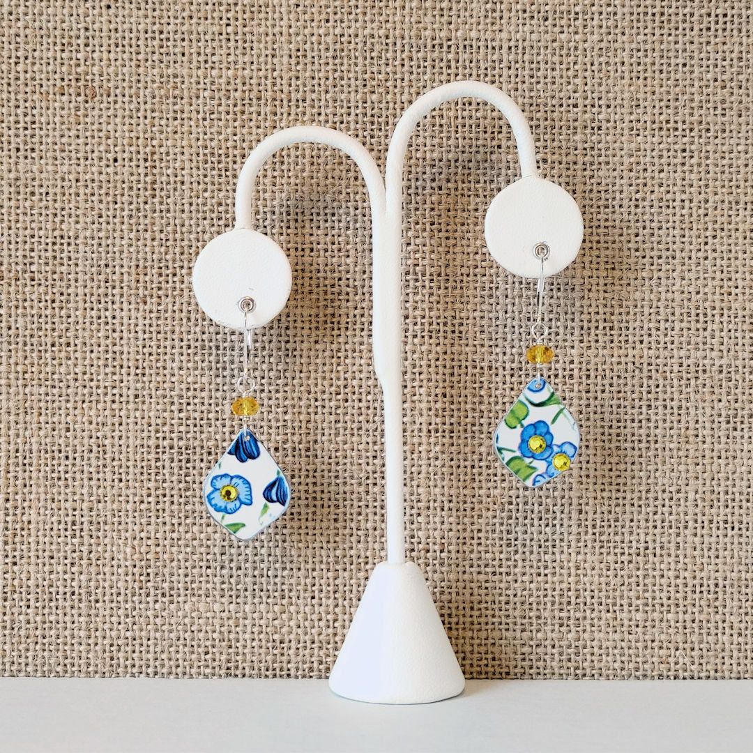 Vintage Elite Tin My Baby Blue Earrings in blue and yellows with white background
